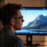 Person looking confidently at a screen showing a finished video.